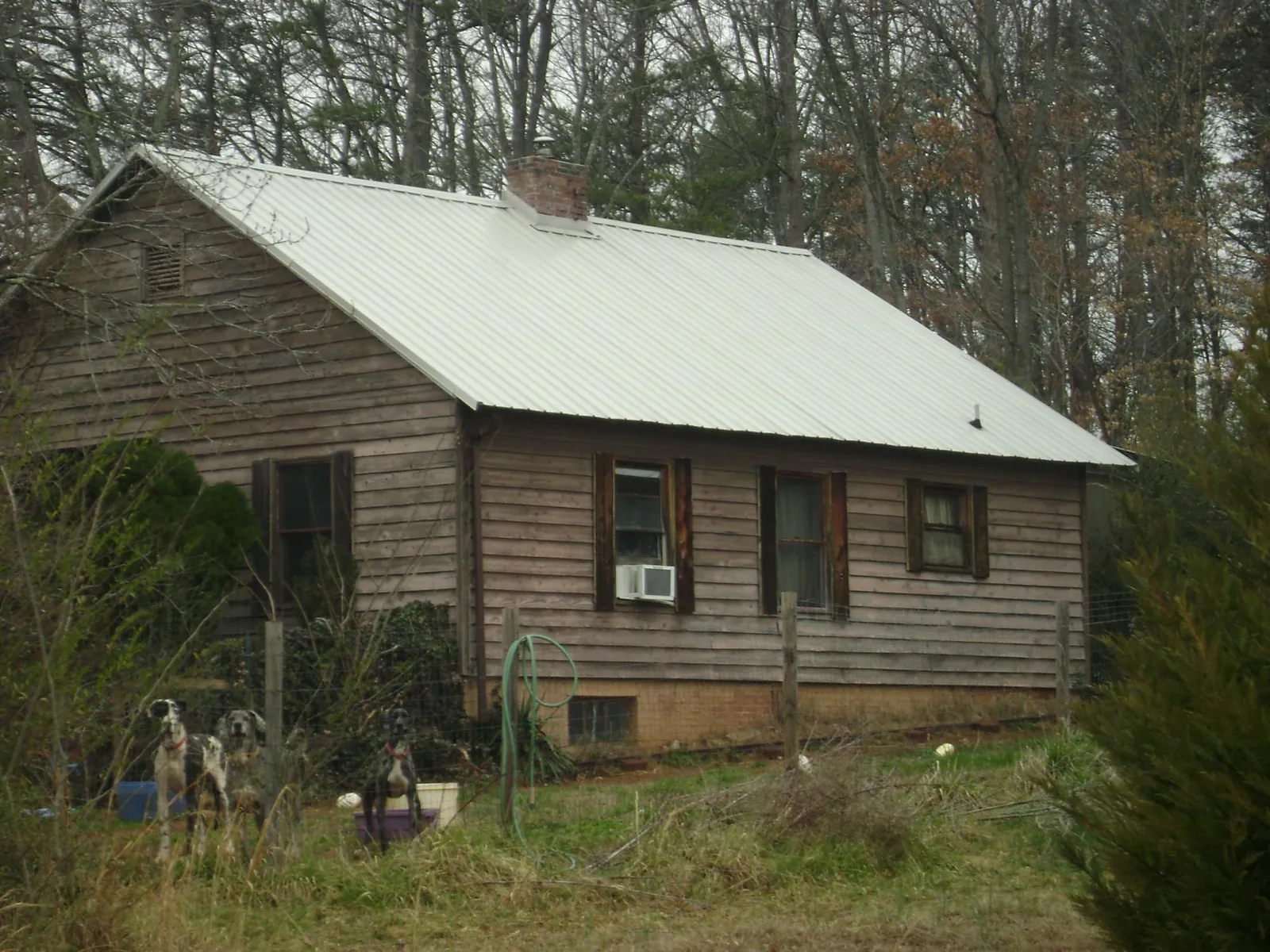 White metal roof on an old wood sided farmhouse, from a Metal Roof Installation job in Donnellson